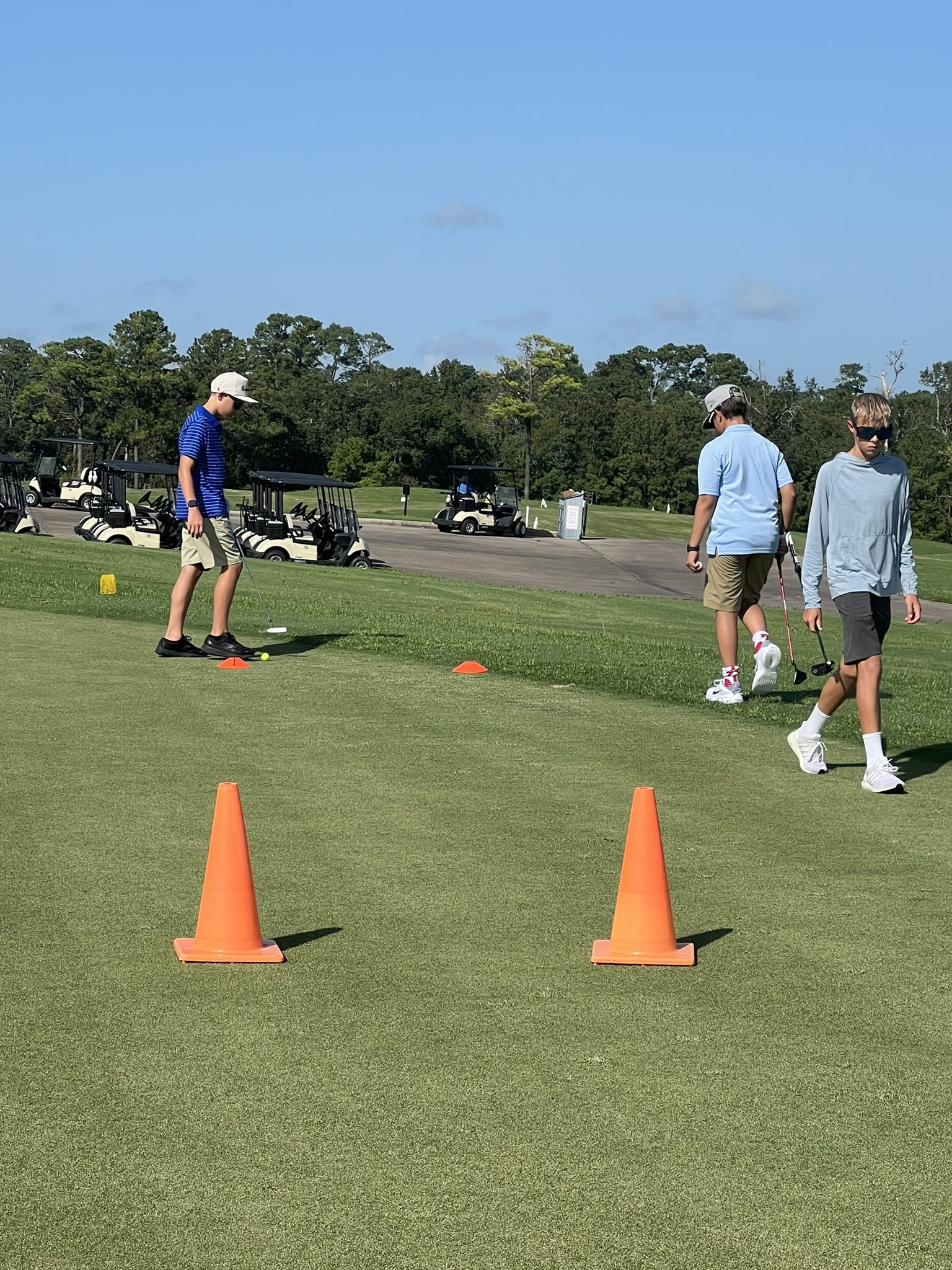 Junior golfer working through a coned drill on the outdoor range at Golf Performance Group